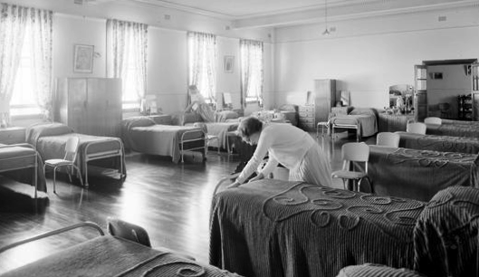 a girl making a bed in a dormitory at the home of the good shepherd girl’s home. ashfield, 8 october, 1963