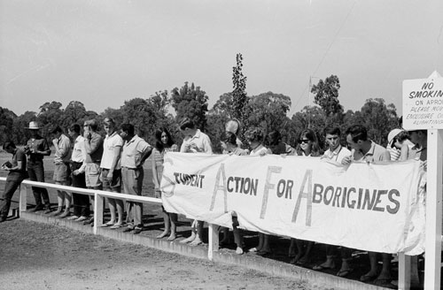 safa members by a roadside with the banner