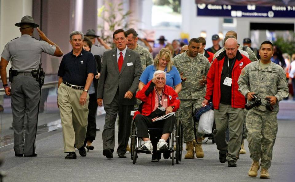 former state sen. john drummond, a world war ii pilot, arrives from an honor flight wednesday. drummond received a surprise welcome from lt. gov. glenn mcconnell and senator nikki setzler.