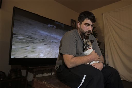 in this photo taken thursday, dec. 17, 2015, josh redmyer, a former marine who served three tours in iraq, poses with milo, who he calls his 
