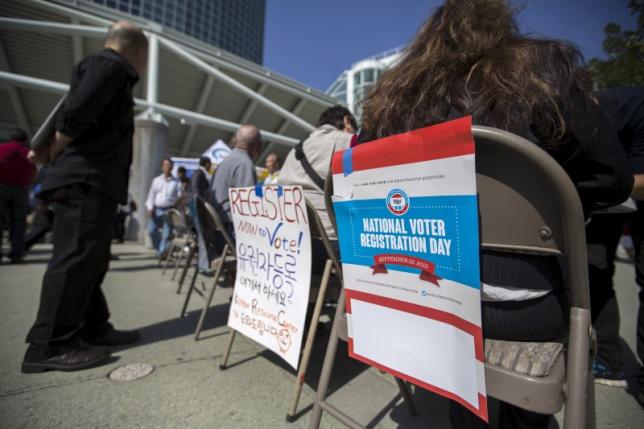 signs are pictured during a voter registration drive for national voter registration day outside convention center in los angeles, california september 22, 2015. reuters/mario anzuoni