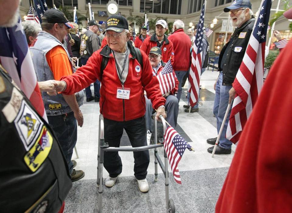 frank meliti joins fellow honor flight veterans as they are welcomed at the columbia metropolitan airport after returning from a day-long trip to washington d.c.