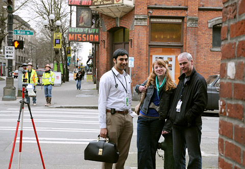 three doctors stand on a street corner in an old part of town