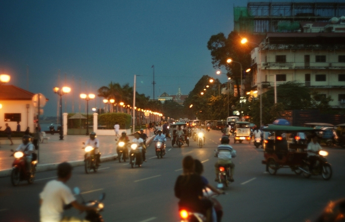 locals roam through the phnom penh promenade on scooters.